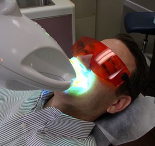 Patient under a zoom whitening light